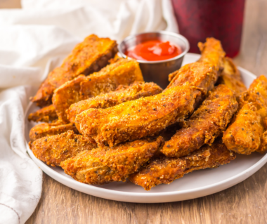 Copycat Buffalo Wild Wings potato wedges tossed in buffalo sauce, served with blue cheese dressing