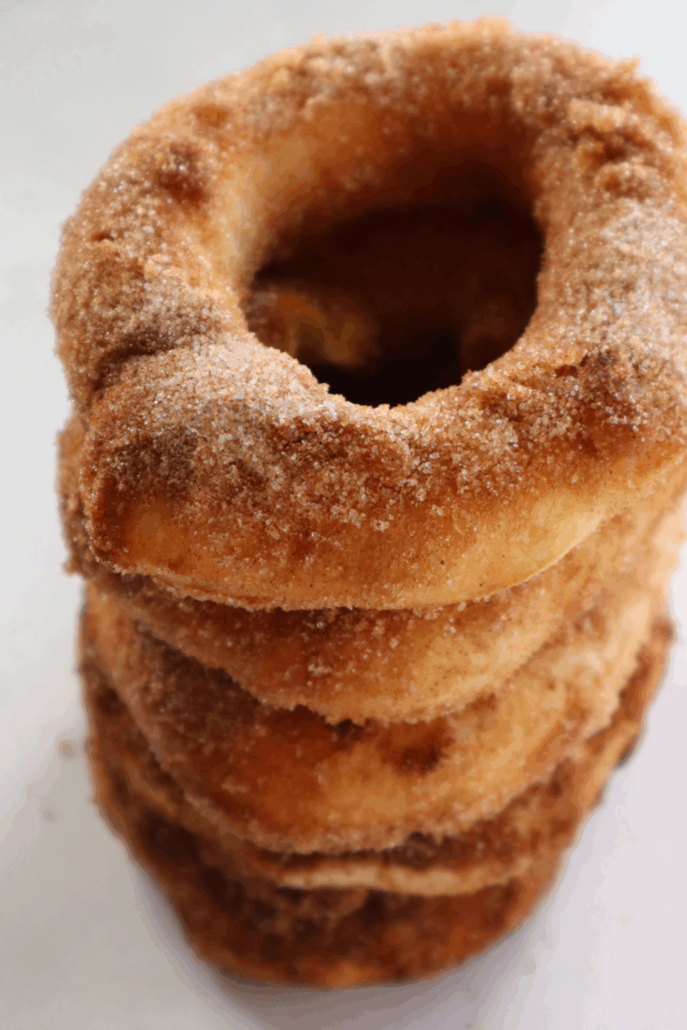 Air fryer donuts with caramel filling oozing from the center, served warm and coated in sugar.