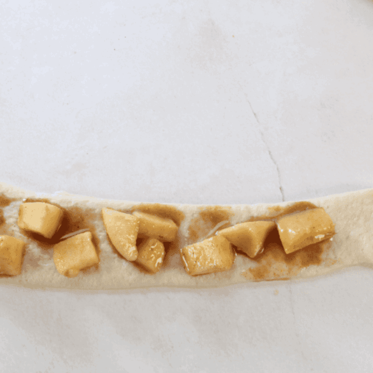 Rolling the pizza dough out and adding some of the caramel stuffing inside.