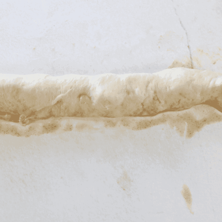 Sealing the donut dough, by pinching the dough together.
