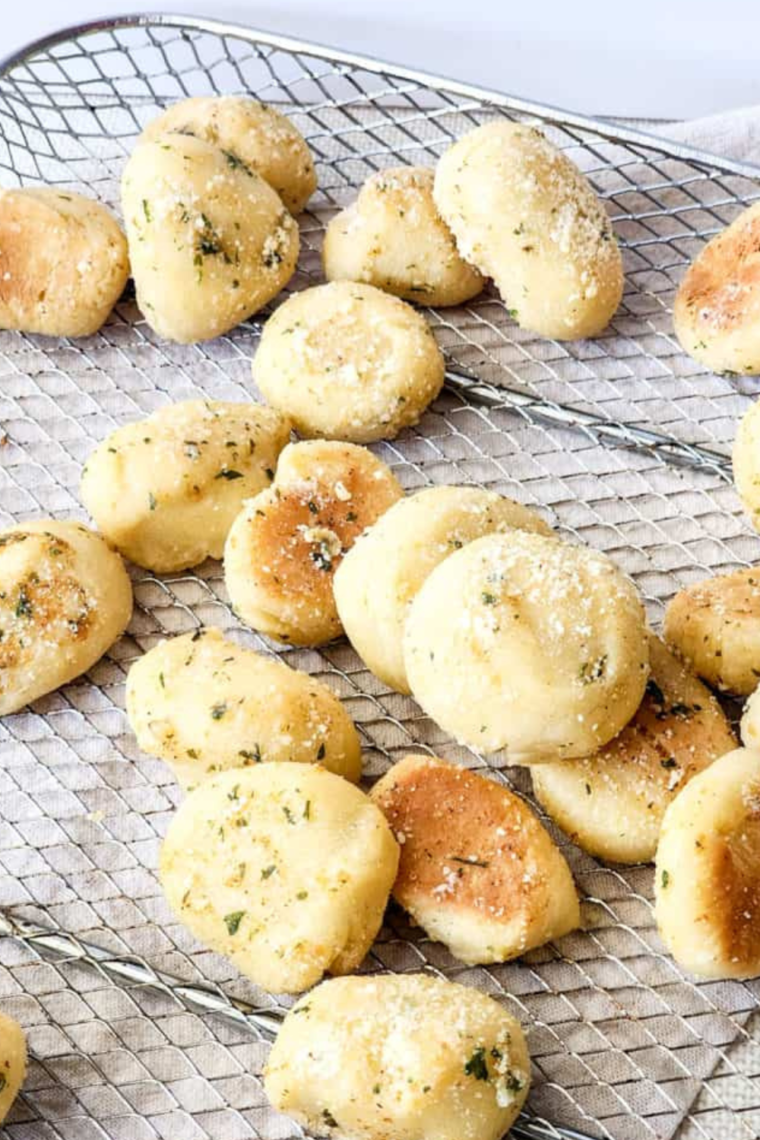 Close-up shot of Air Fryer Copycat Domino’s Parmesan Bites, highlighting the crunchy exterior and melted Parmesan cheese.