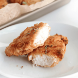 Plate of golden air fryer cornbread crusted chicken tenders made with Jiffy mix, served with honey mustard
