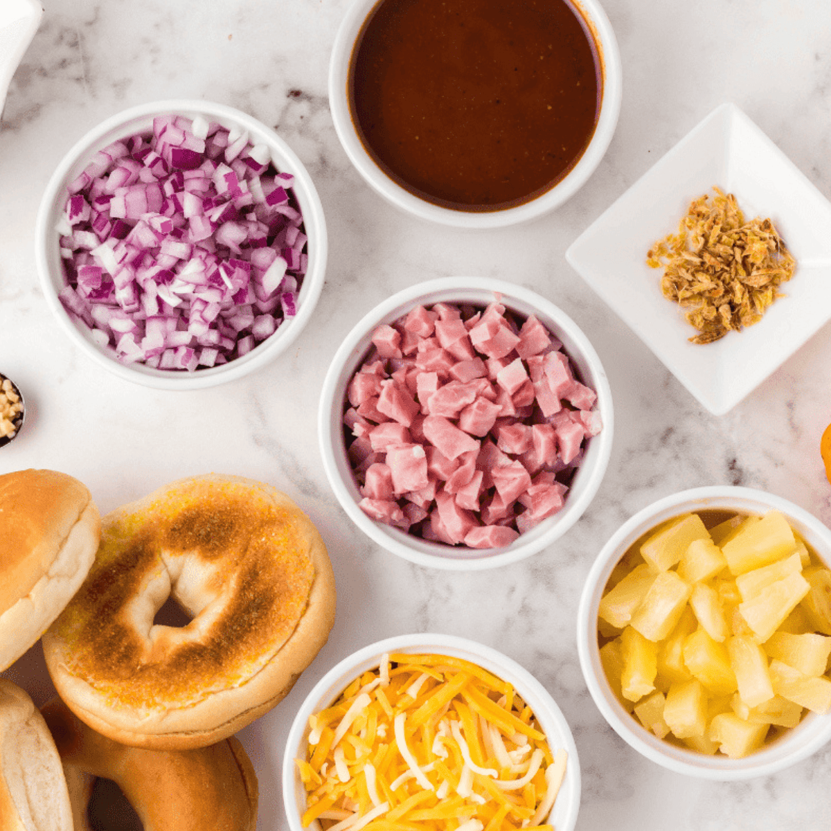 Ingredients needed for Air Fryer Hawaiian Pizza Bagel Bites on kitchen table.