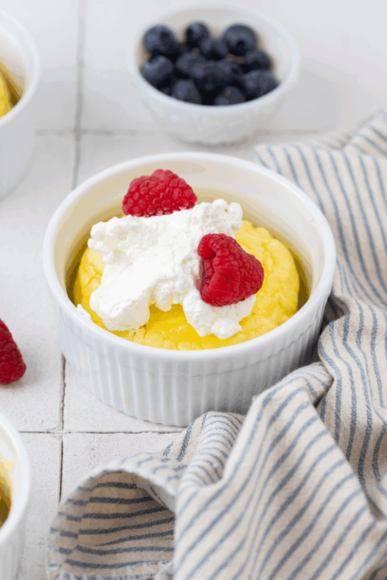 Golden, fluffy air fryer souffl&eacute; pancakes served with whipped cream, maple syrup, and fresh berries.
