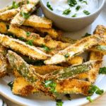 Who doesn't love french fries? Fries are often considered a guilty-pleasure indulgence, but you can still enjoy the deliciousness without feeling guilty! Vegan Zucchini Fries cooked in an air fryer are just as satisfying and taste equally amazing. They're also much healthier than traditional fried french fries, so you don't need to worry about unwanted calories. Plus they only take 15 minutes to make! In this blog post, learn everything you need to bring Vegan Zucchini Fries straight from your kitchen into your home for easy snacking. You'll wow everyone with their crunchy yet delicate texture and subtle flavor of zesty spices that will leave everyone wanting more. Read on if you’re ready for an all vegan deep-fried treat alternative that is sure to tantalize taste buds!