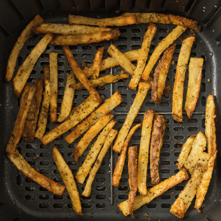Air fryer copycat Wendy's french fries with browned skin edges served in a air fryer basket