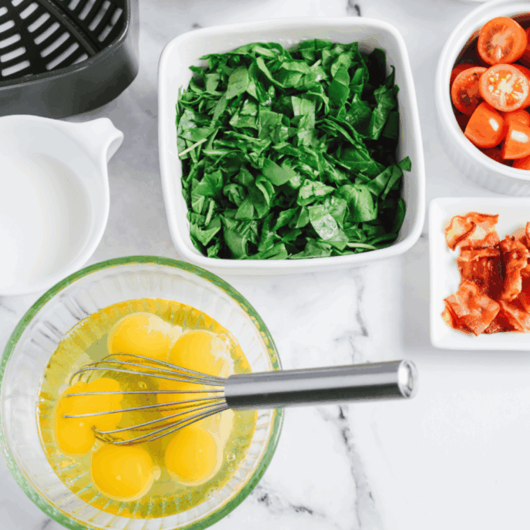 Chopping spinach, tomatoes, and dicing bacon into small pieces for easy prep.