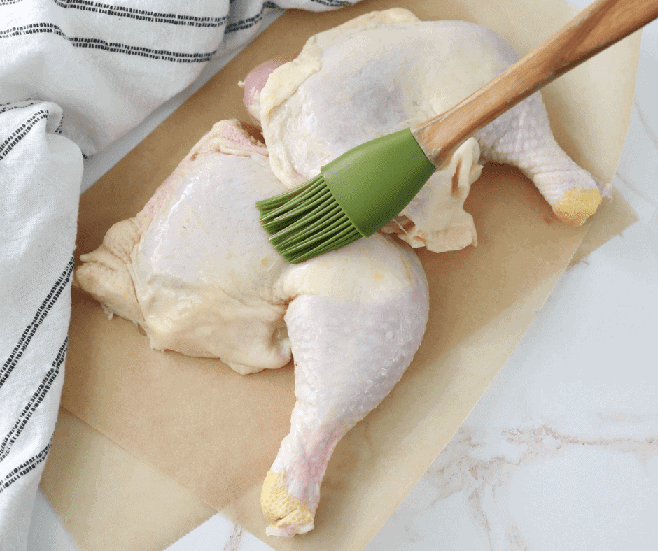 brushing oil on chicken quarters in air fryer