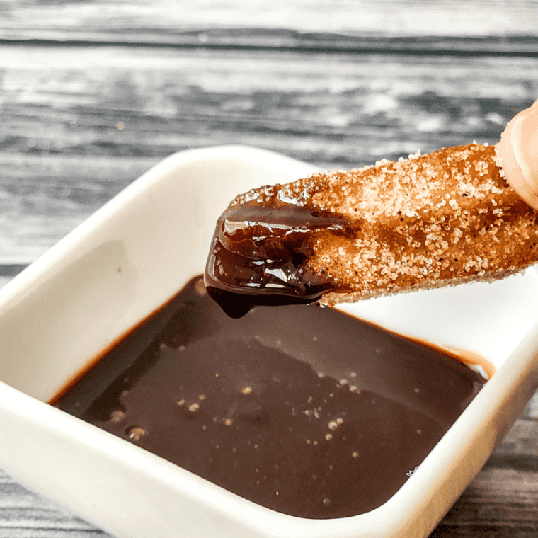 Disneyland-style churros dusted with cinnamon sugar, crispy on the outside and soft on the inside, ready to be enjoyed.