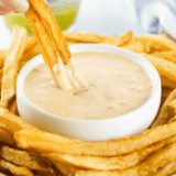 Small bowl of creamy Copycat Freddy&rsquo;s Fry Sauce with a side of golden fries