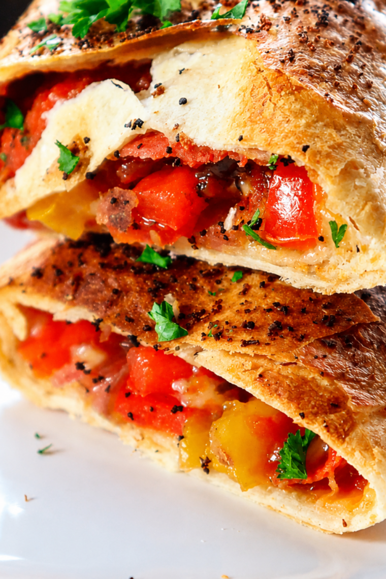 Golden air fryer turkey wraps stacked on a plate with marinara for dipping