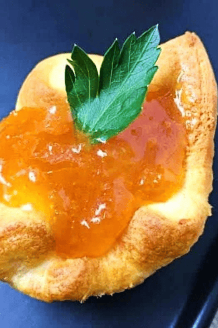 Close up of orange marmalade on toast showing the citrus peel shreds