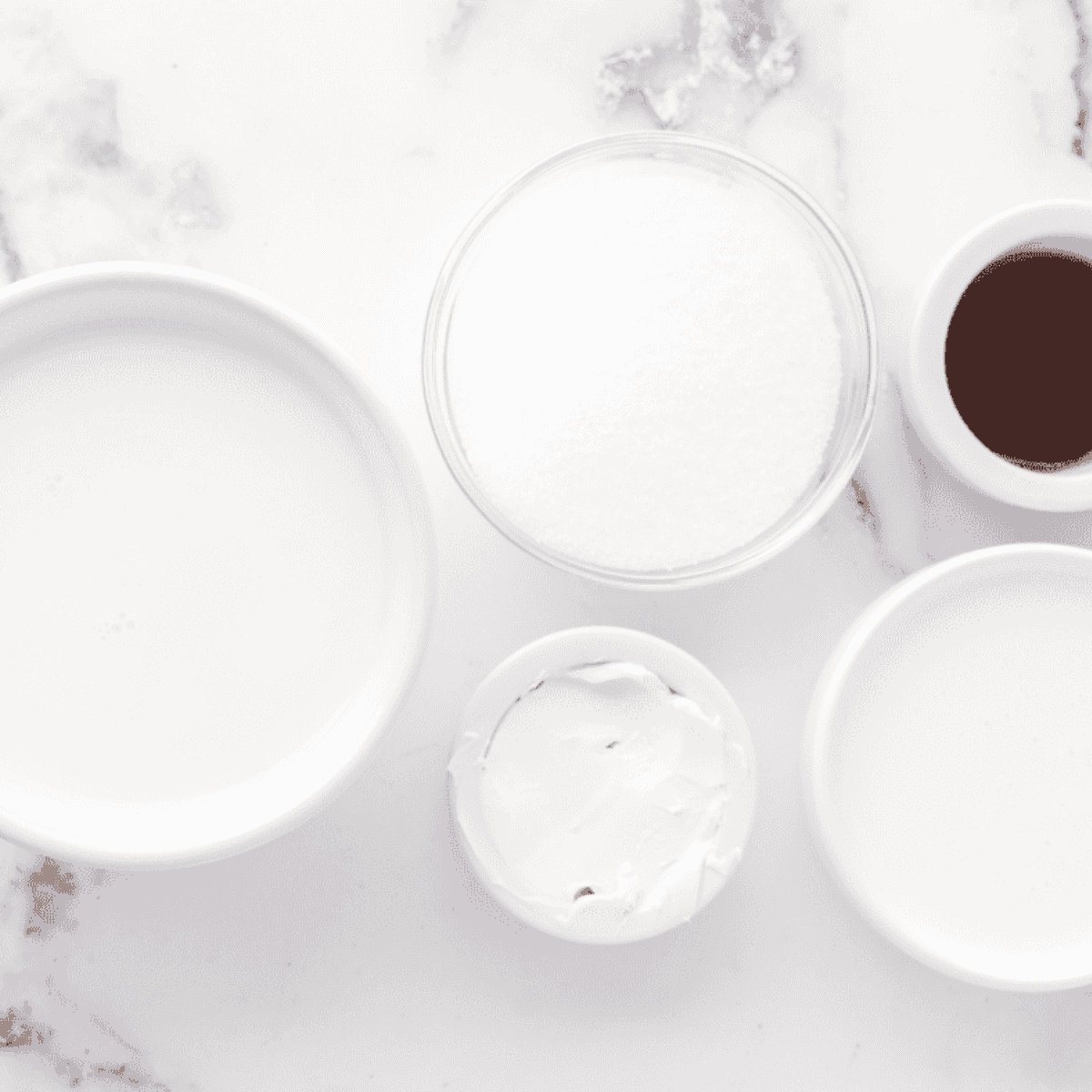 Ingredients needed for Ninja Creami Vanilla Bean Ice Cream on kitchen table.