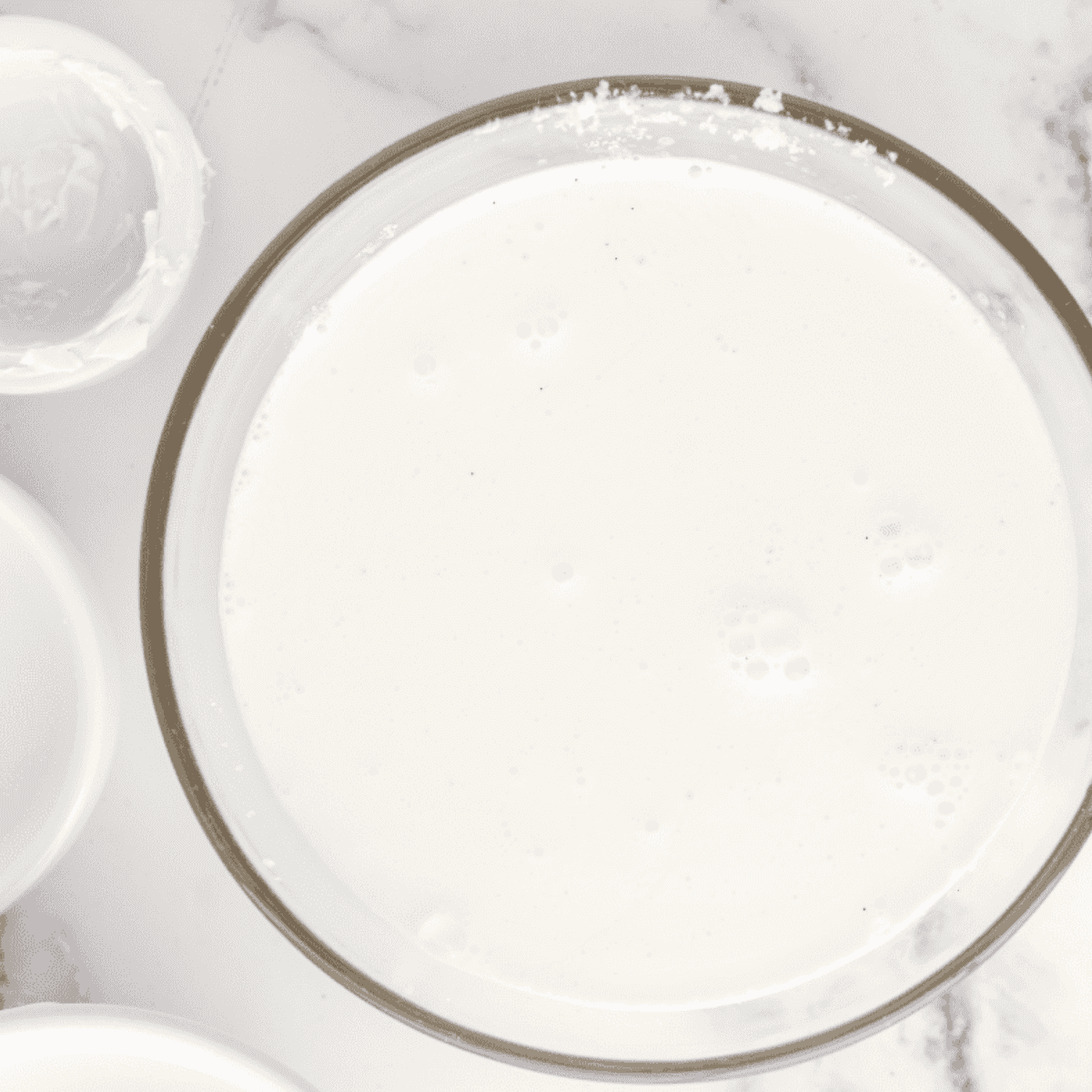 Ninja Creami Vanilla Bean Ice Cream ingredients blended in a mixing bowl.