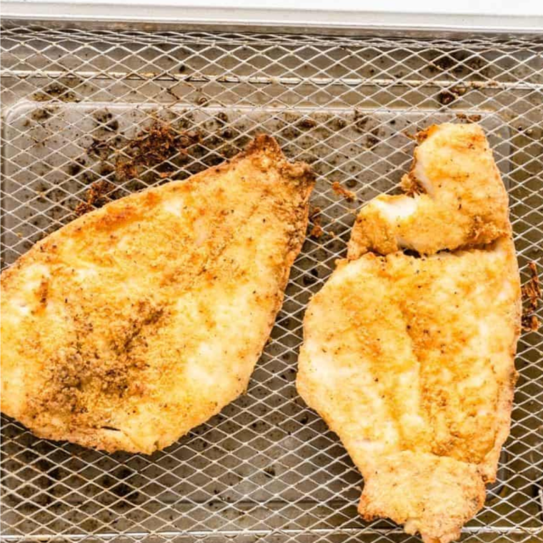 Cooked Popeyes Fish Sandwich Copycat Recipe on air fryer tray.