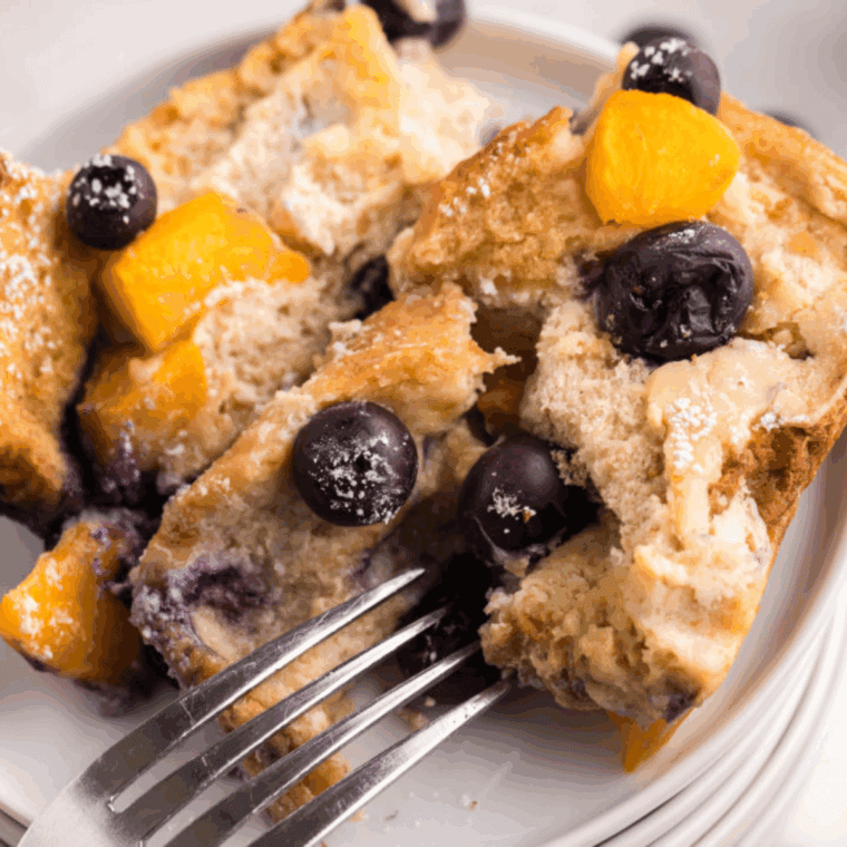 Golden-baked sourdough French toast casserole with cinnamon and custard in a white baking dish, ready to serve.