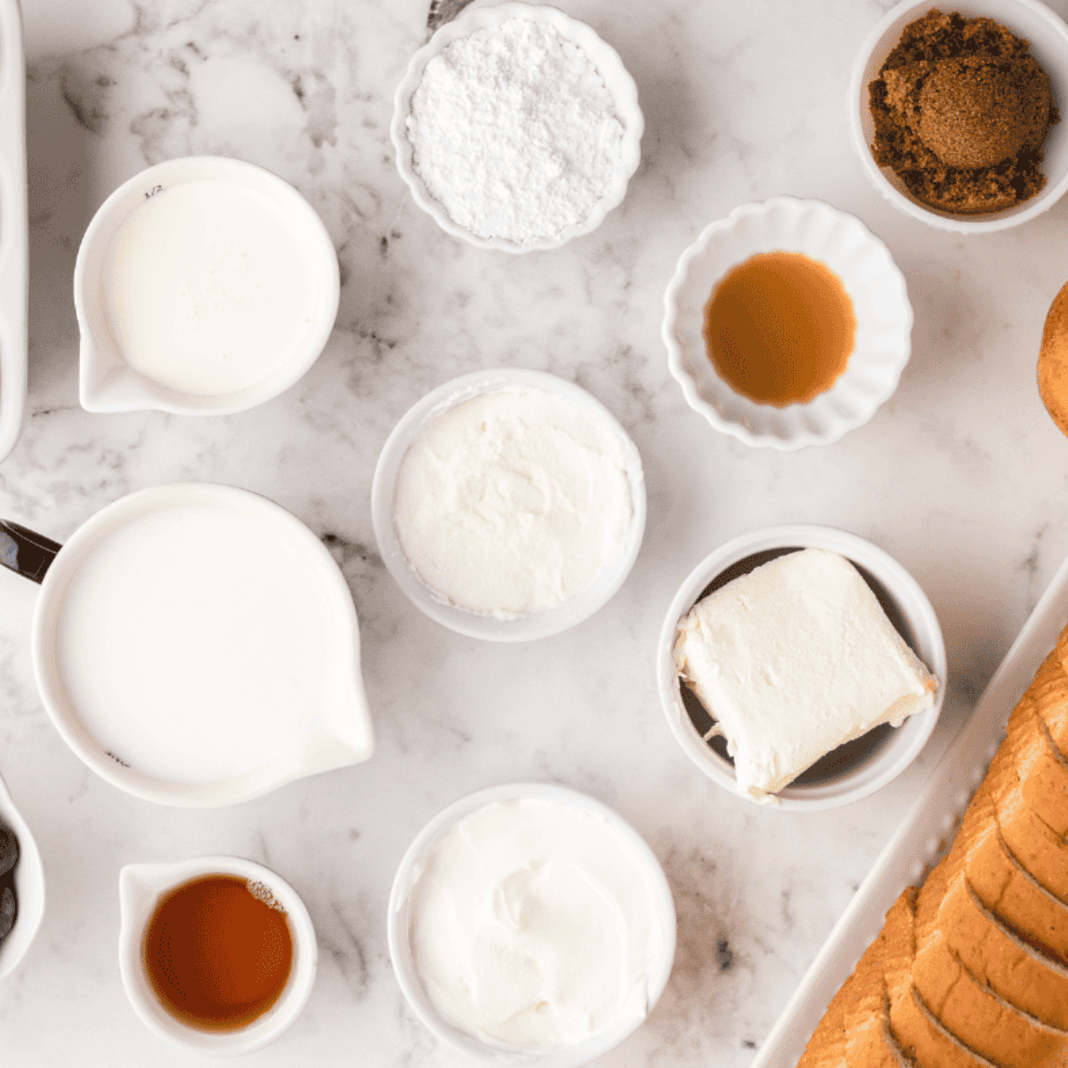 Ingredients needed for Sourdough French Toast Casserole on kitchen table.
