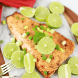 Air fryer firecracker salmon glazed with sweet chili sauce, topped with lime slices and diced scallions