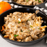 Air fryer sausage gravy breakfast skillet served on a plate, crispy hash browns topped with creamy homemade sausage gravy