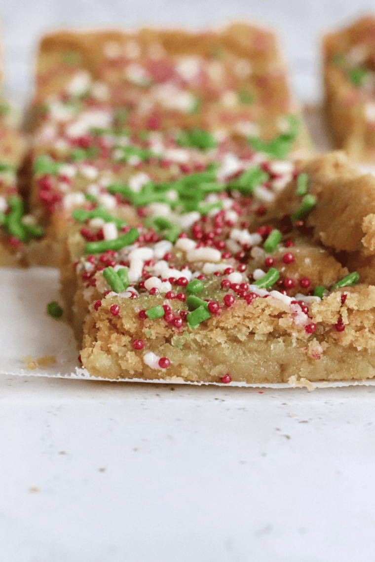 Golden sugar cookie bars fresh from the air fryer, cut into squares and topped with sprinkles.
