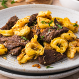 Blackstone tortellini cooked on griddle with sausage, cheese pasta, and vegetables