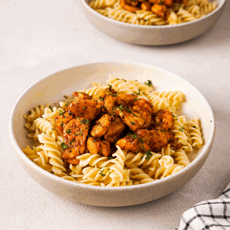 Cheesecake Factory copycat New Orleans Cajun Shrimp served with Cajun-seasoned shrimp garnished with fresh herbs.