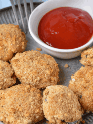 Golden crispy air fryer fried zucchini slices, served with dipping sauce, inspired by Cheesecake Factory.