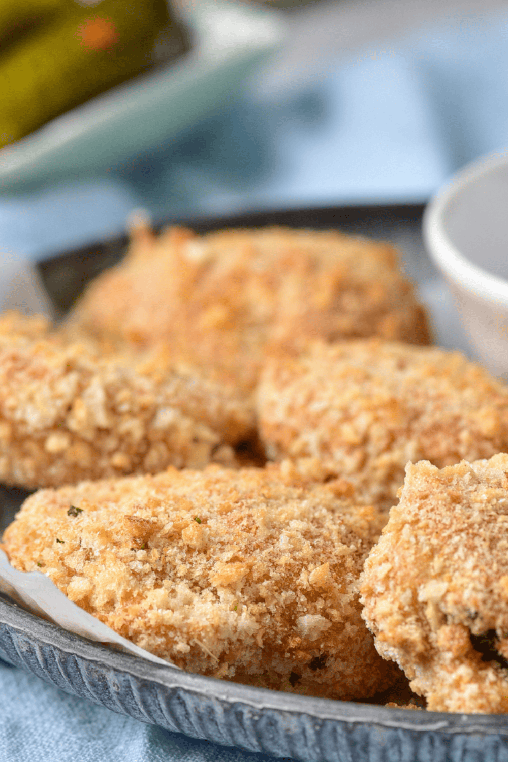 Golden and crispy air fryer fried zucchini rounds inspired by the Cheesecake Factory, served with dipping sauce.