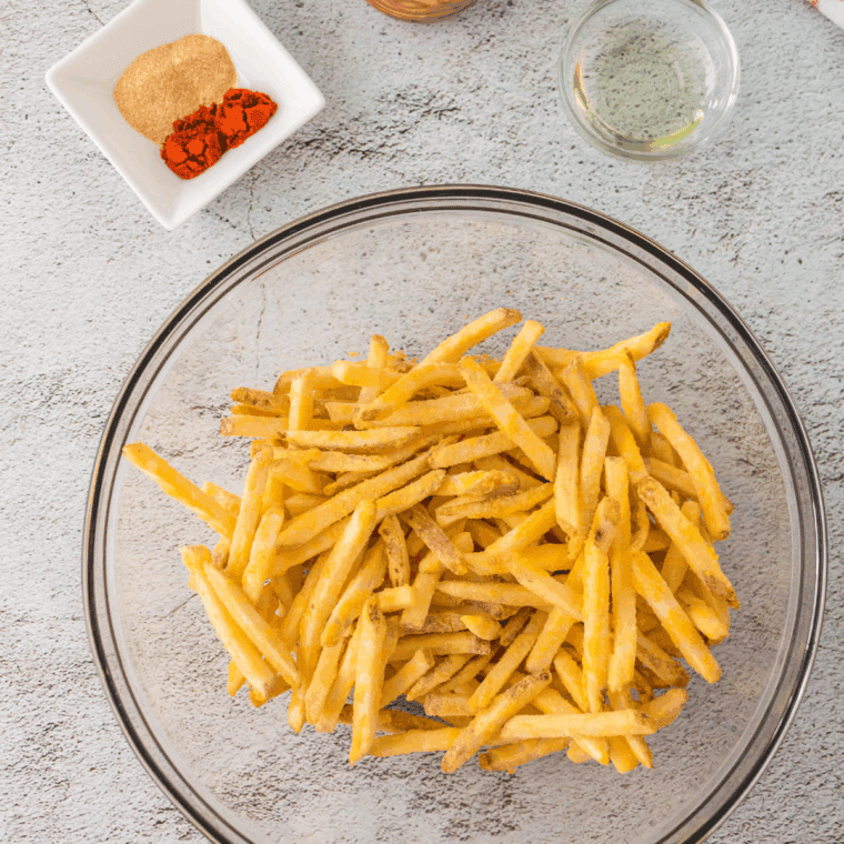 Ingredients needed for Copycat Hardee's Seasoned Fries on kitchen table.