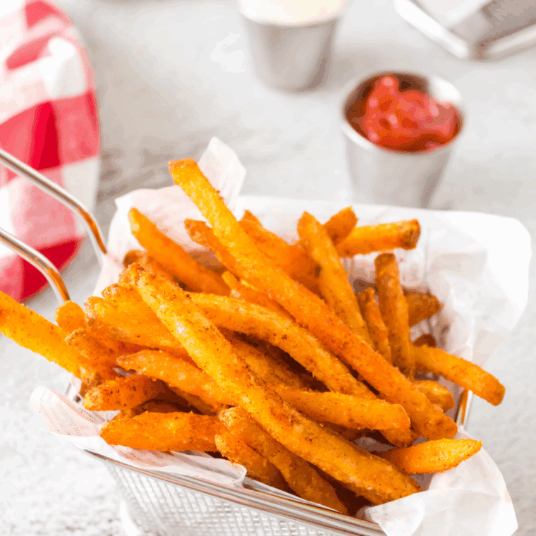 Basket of Copycat Hardee's Seasoned Fries with dipping sauce.