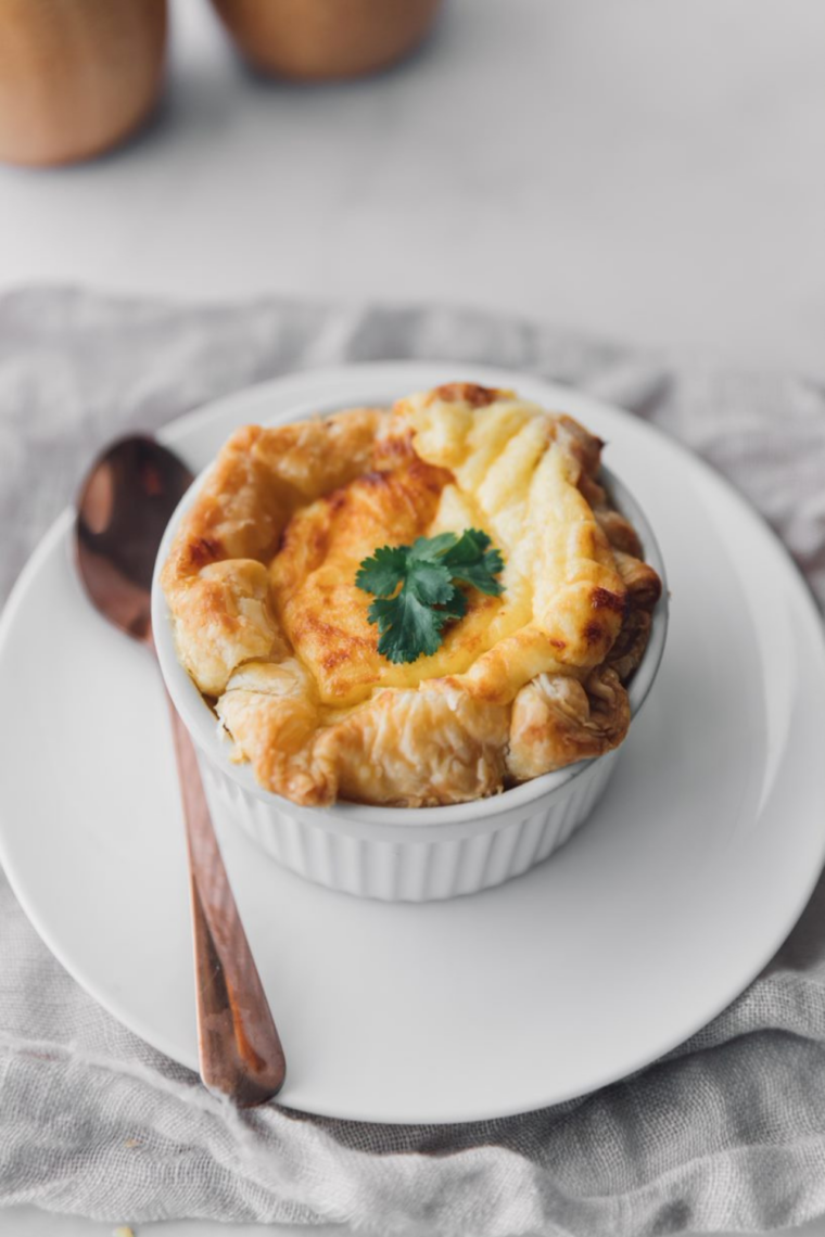 Copycat Panera four cheese soufflé served on a white plate, golden brown with a flaky puff pastry crust