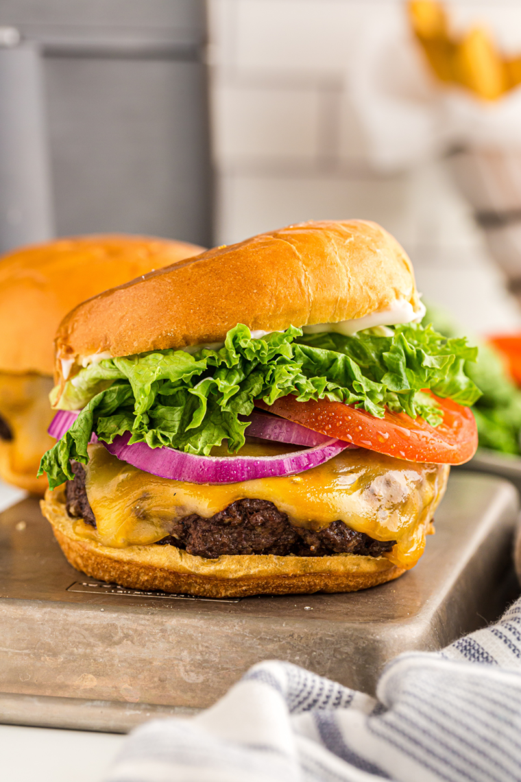 Copycat Wendy's Dave's Single Burger with grilled chicken, fresh toppings, and a toasted bun, served on a plate.