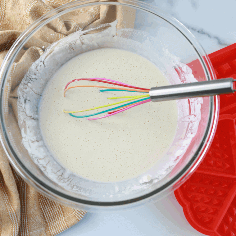 Stirring wet and dry ingredients to form waffle batter