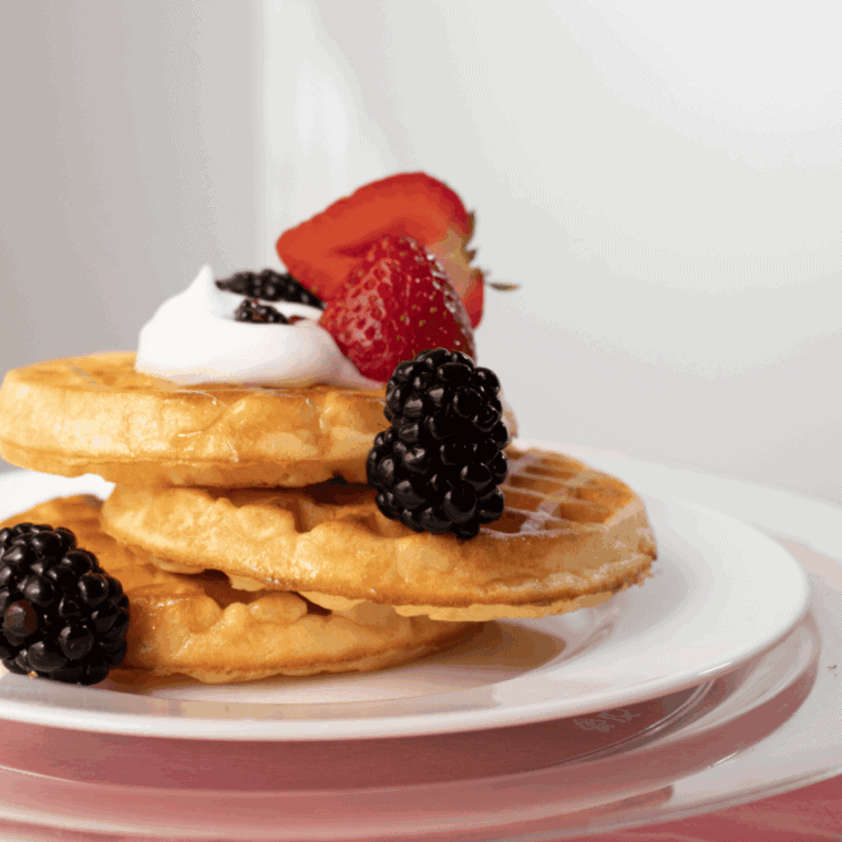 Serving dairy-free waffles with syrup and fresh toppings