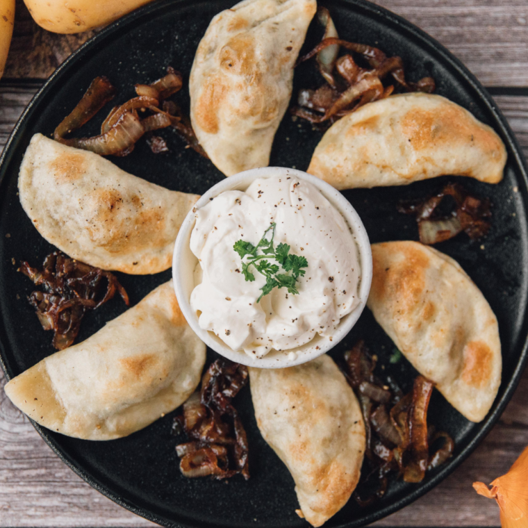 Golden potato and cheese pierogies served with caramelized onions and a dollop of sour cream.