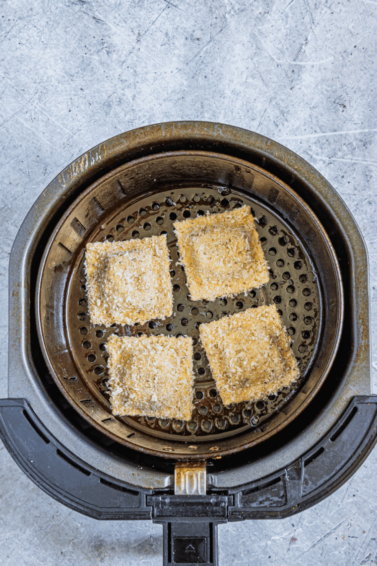 Low carb ravioli coated in oil and seasonings, arranged in a single layer in the air fryer basket, preheated to 375&deg;F