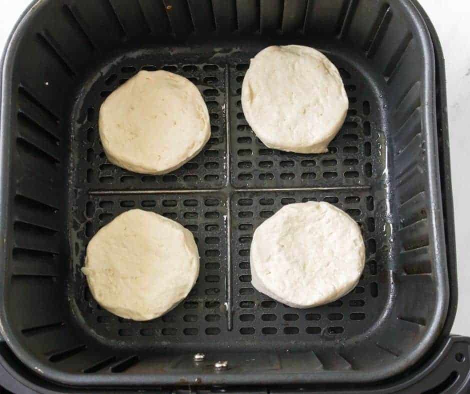 overhead: biscuits in air fryer basket for jelly donuts