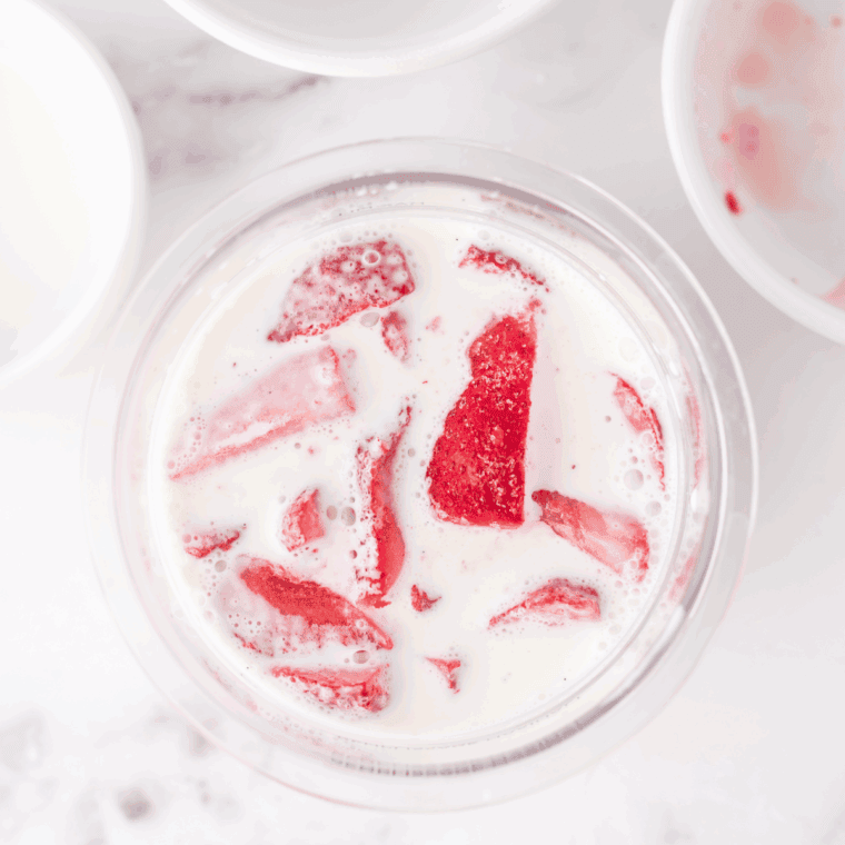 Add fresh strawberries to the Ninja Creami Pint Container.