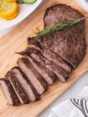 Blackstone sirloin steak with a crispy seared crust sliced on a cutting board