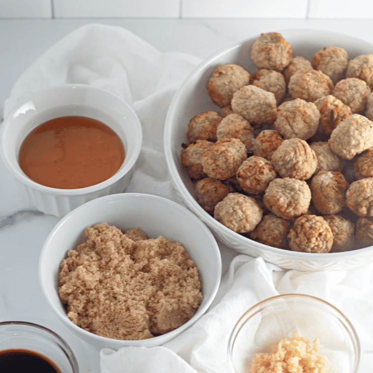 Browned turkey meatballs on a foil-lined baking sheet after broiling