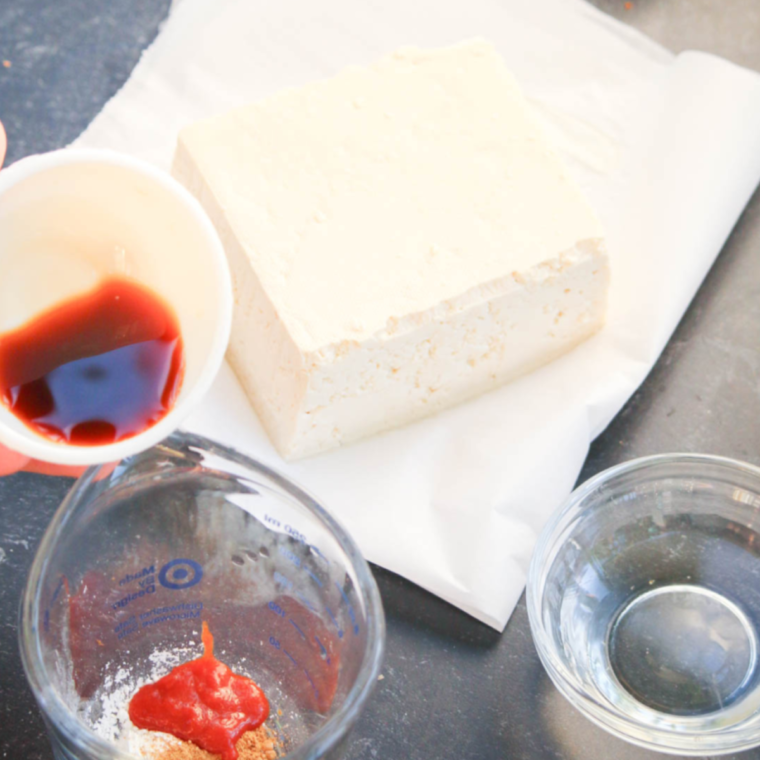 Ingredients for Air Fryer Agedashi Tofu arranged on a table, including tofu, cornstarch, and sauce components.