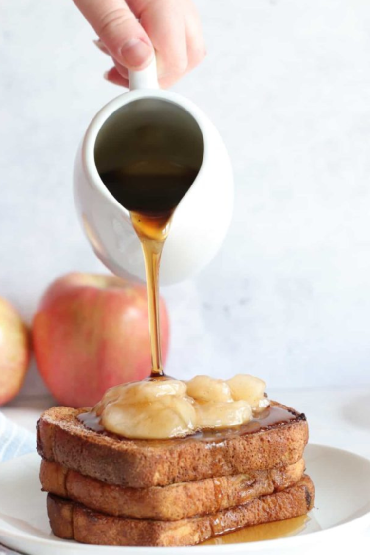 Golden brown Air Fryer Apple Pie French Toast with a crispy exterior and soft interior, drizzled with melted butter.