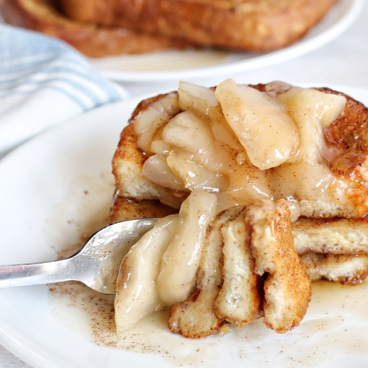 Golden brown Air Fryer Apple Pie French Toast topped with apple pie filling and a dusting of cinnamon.