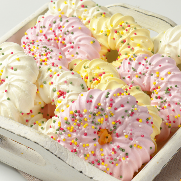 Delicate Air Fryer meringue cookies displayed on a plate, showcasing their light, airy texture and golden edges.