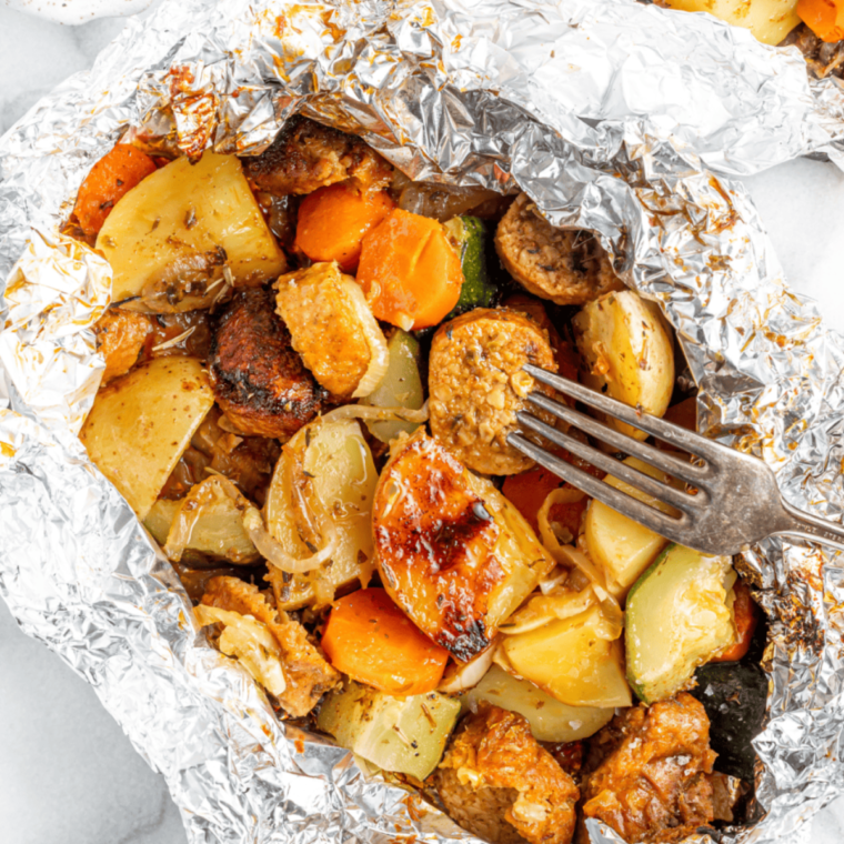 Close-up view of perfectly cooked sausage and veggies from the air fryer.