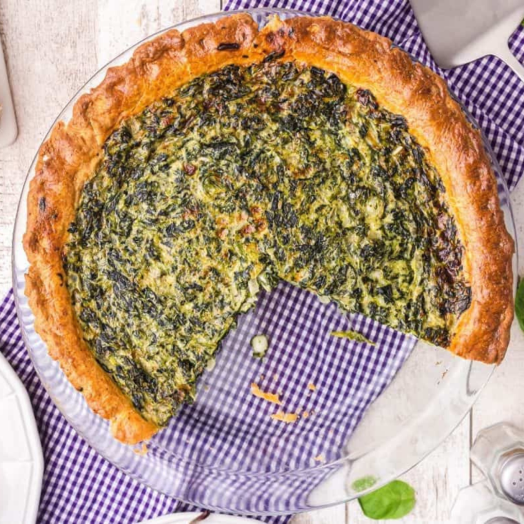 Air Fryer Spinach Quiche with golden crust, fresh spinach, and creamy cheese filling in air fryer basket