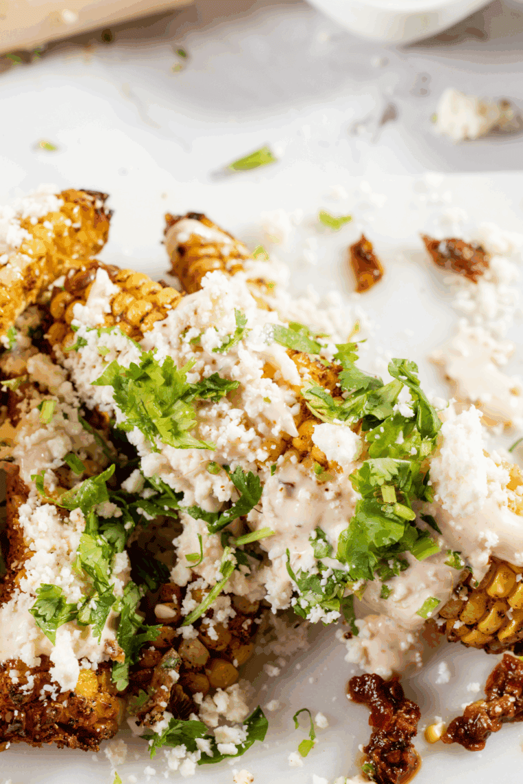 Golden air fryer corn ribs topped with chipotle mayo, cotija cheese, and fresh cilantro.