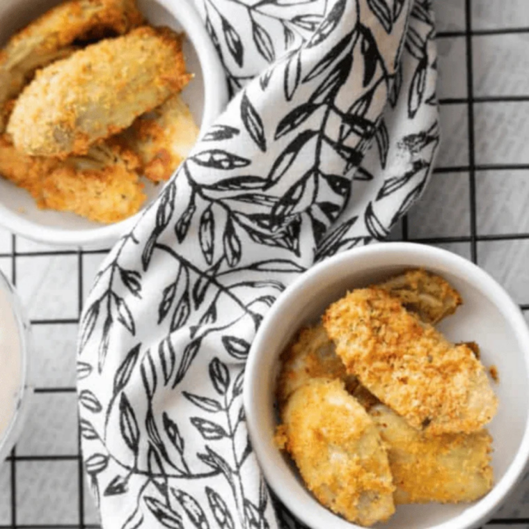 Golden breaded air fryer artichoke hearts served as an easy appetizer