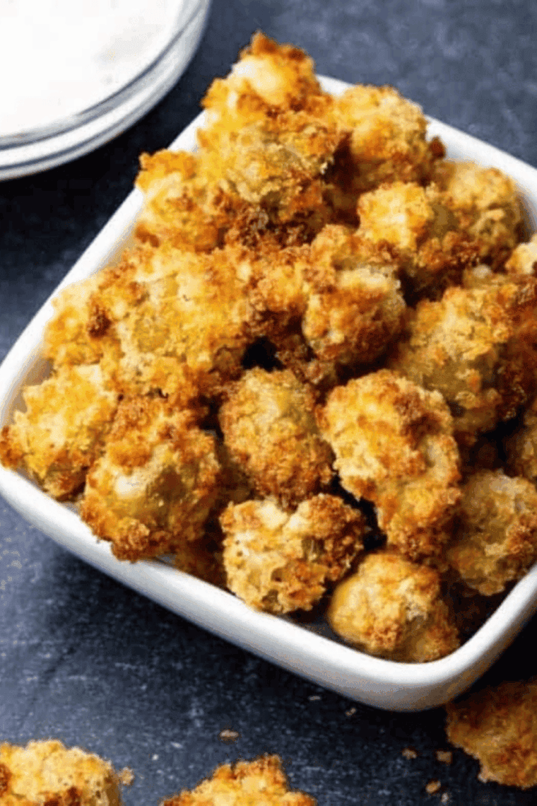 Golden crispy air fryer fried olives served in a small bowl, perfect for an easy appetizer or snack.