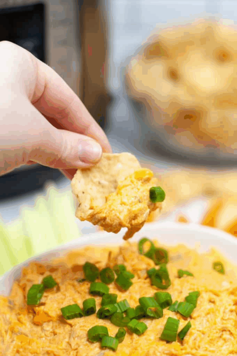 Instant Pot Buffalo Chicken Dip served hot in a bowl with tortilla chips for dipping